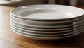 Stack of White Ceramic Plates on Wooden Table Royalty Free Stock Photo