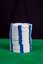 Stack of white chips on a green playing table