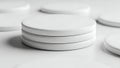 Stack of white circular objects on a white surface Royalty Free Stock Photo