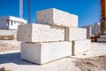 Stack of white construction bricks on a building site under a clear blue sky Royalty Free Stock Photo