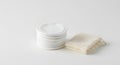 Stack of white cotton pads and washcloth on white background Royalty Free Stock Photo