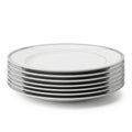 Stack of White Dinner Plates with Silver Rim Detail on White Background dinnerware dish Royalty Free Stock Photo
