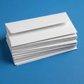 A stack of white envelopes is neatly arranged on a blue surface Royalty Free Stock Photo