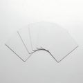 Stack of white fabric or paper with folded edges placed on a flat surface Royalty Free Stock Photo