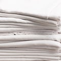 Stack of white folded cotton tablecloths Royalty Free Stock Photo