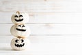 Stack of white ghost pumpkin on white wooden background.