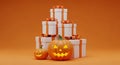 Stack of White Gift Boxes with Orange Ribbons and Halloween Pumpkins gifts presents Royalty Free Stock Photo