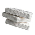 Stack of white mattresses isolated on a white or transparent background. Spring mattresses close-up, side view. Graphic Royalty Free Stock Photo