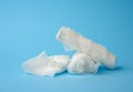 Stack of white medical gauze cotton bandages on a blue background