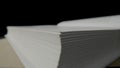 A stack of white pages of an open book that lies on a black isolated studio background. White empty sheets of paper book Royalty Free Stock Photo