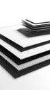 Stack of white paper or cardstock sheets with a textured grey layer at the bottom, presented on a clean white background Keywords Royalty Free Stock Photo