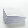 A stack of white paper documents on a clean surface. The top sheet is partially visible, Royalty Free Stock Photo