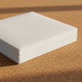 A stack of white paper is placed on a brown cork surface with a fine, granular texture. Royalty Free Stock Photo