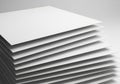 A stack of white paper sheets is arranged neatly, creating a Royalty Free Stock Photo