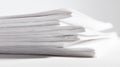 Stack of white paper sheets close up on white surface Royalty Free Stock Photo