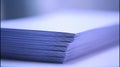 Stack of white paper sheets close up on white surface Royalty Free Stock Photo