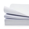 Stack of white paper sheets with a corner lifted on top of a patterned sheet Royalty Free Stock Photo