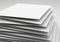 A stack of white paper sheets is neatly arranged in a staggered formation, showcasing their edges. Royalty Free Stock Photo