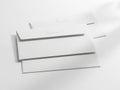 Stack of white paper sheets with a pen resting on top in a minimalist setting Royalty Free Stock Photo