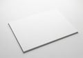 A stack of white paper sheets is placed on a smooth white surface Royalty Free Stock Photo