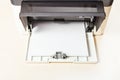 Stack of white paper sheets in printer tray