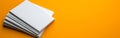 stack of white paper on vibrant orange background, showcasing simplicity and organization. clean lines and bright color create Royalty Free Stock Photo