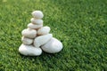 Stack of white pebble stones on artificial grass Royalty Free Stock Photo