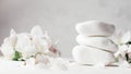 Stack of white pebble stones on light plaster surface, with apple flowers. Banner Royalty Free Stock Photo