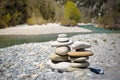 Stack of white pebbles stone against blue mountain stream background