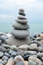 Stack of white pebbles stone against blue sea background for spa, balance, meditation and zen theme Royalty Free Stock Photo