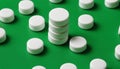 A stack of white pills on a green background Royalty Free Stock Photo