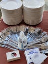 Stack of white plates, alcohol gel, paper napkin and group of folk and spoon set on table prepared for buffet or partyÃ Â¹Æ Royalty Free Stock Photo