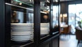 Stack of white plates in black glass front cabinet in modern dining room Royalty Free Stock Photo