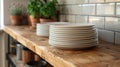 Stack of white plates on wooden kitchen counter Royalty Free Stock Photo