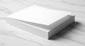 A stack of white printer paper lies on a smooth, light-colored, marble surface. The Royalty Free Stock Photo