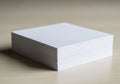 A stack of white, rectangular paper sits on a light wooden surface Royalty Free Stock Photo