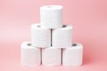 A stack of white rolls in toilet paper on a pink background close up. Royalty Free Stock Photo