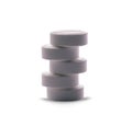 Stack of white round pills on white background Royalty Free Stock Photo