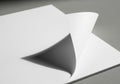 A stack of white sheets of paper with the top corner turned Royalty Free Stock Photo