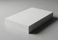 A stack of white, A4-sized paper rests on a smooth gray surface Royalty Free Stock Photo