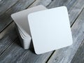 Stack of white square beer coasters