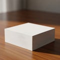 A stack of white square paper sheets sits neatly on a wooden surface Royalty Free Stock Photo