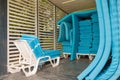 Stack of white sun beds and blue mattres under wooden gazebo or canopy Royalty Free Stock Photo