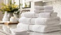 A stack of white towels on a counter by AI generated image Royalty Free Stock Photo