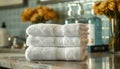 A stack of white towels on a counter by AI generated image Royalty Free Stock Photo