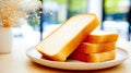 Whole Grain Bread Slices Stacked on a Ceramic Plate Illuminated by Natural Light on a Wooden Table Royalty Free Stock Photo