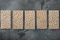 Stack of wholegrain crispy bread with sunflower, chia and sesames seeds, on gray stone table background, top view flat lay, with Royalty Free Stock Photo