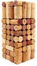 Stack of wine corks showing natural texture and hints of wine stains against a white background Royalty Free Stock Photo