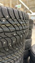 Stack of winter tires with visible treads in a store setting, suitable for background use Royalty Free Stock Photo