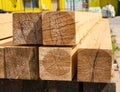 A stack of wooden balks, wooden balks, beams at a sawmill, a warehouse of beams on the site of a building materials store. Wood,